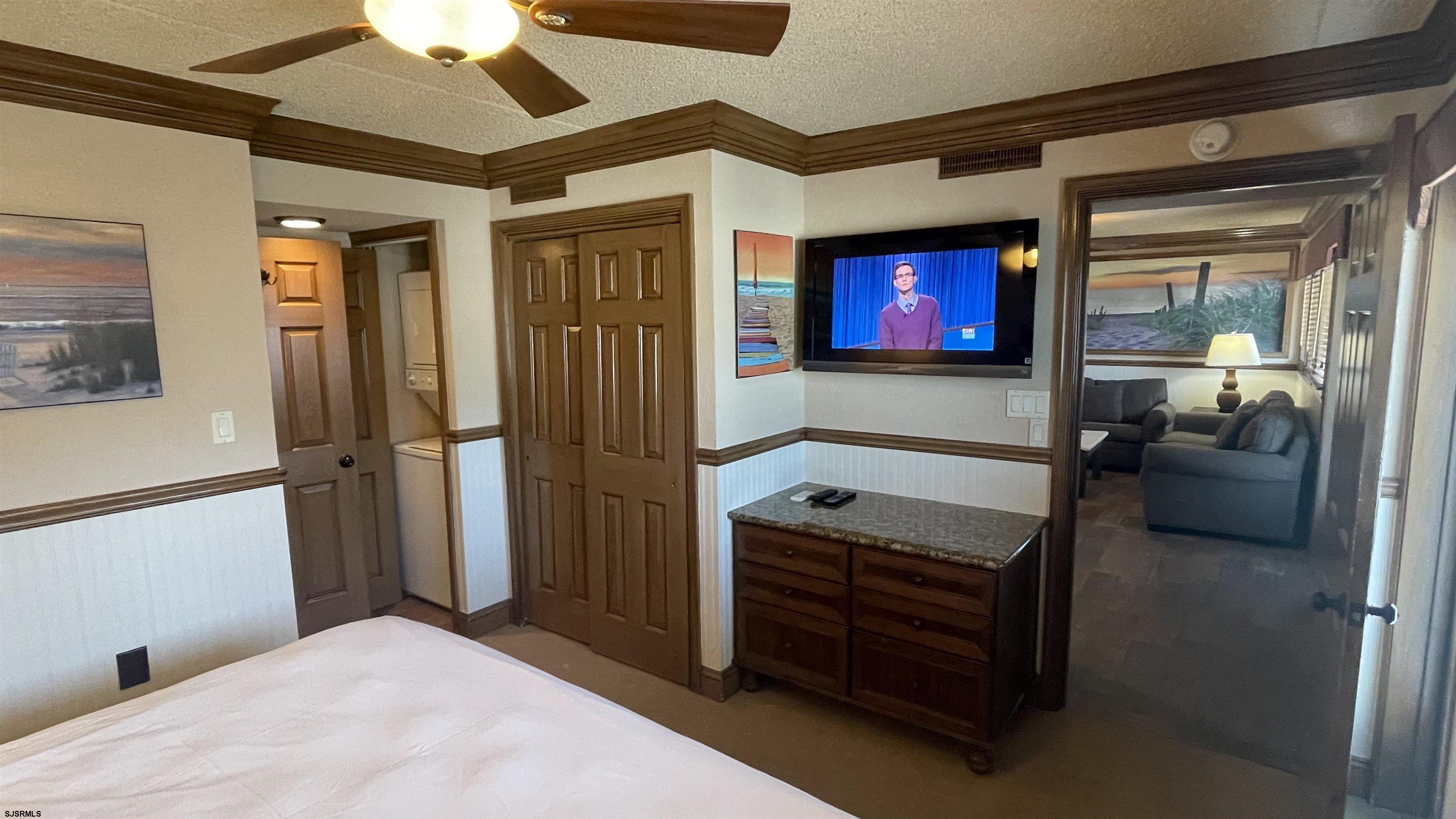 820 Ocean Avenue, Unit 115 Ocean City, NJ 08226 - Photo 25 of 58 a bedroom with furniture and a flat screen tv