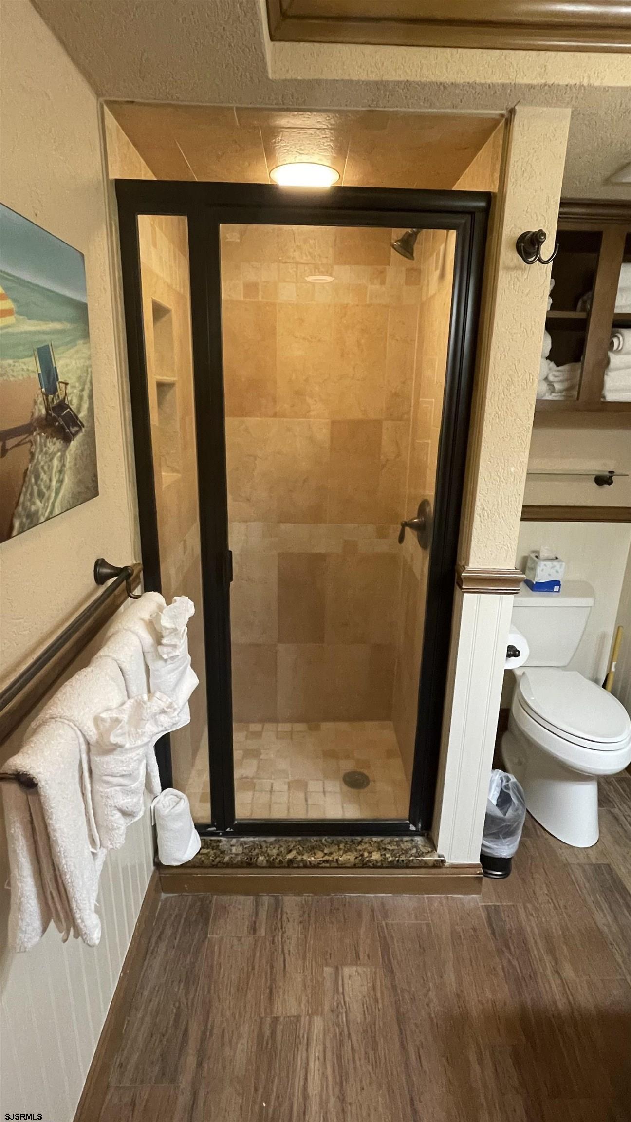 820 Ocean Avenue, Unit 115 Ocean City, NJ 08226 - Photo 31 of 58 a bathroom with a toilet and a shower