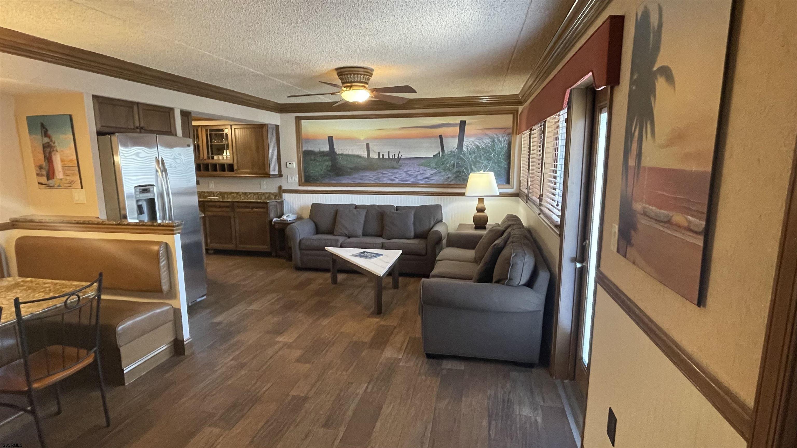 820 Ocean Avenue, Unit 115 Ocean City, NJ 08226 - Photo 33 of 58 a living room with furniture and a large window