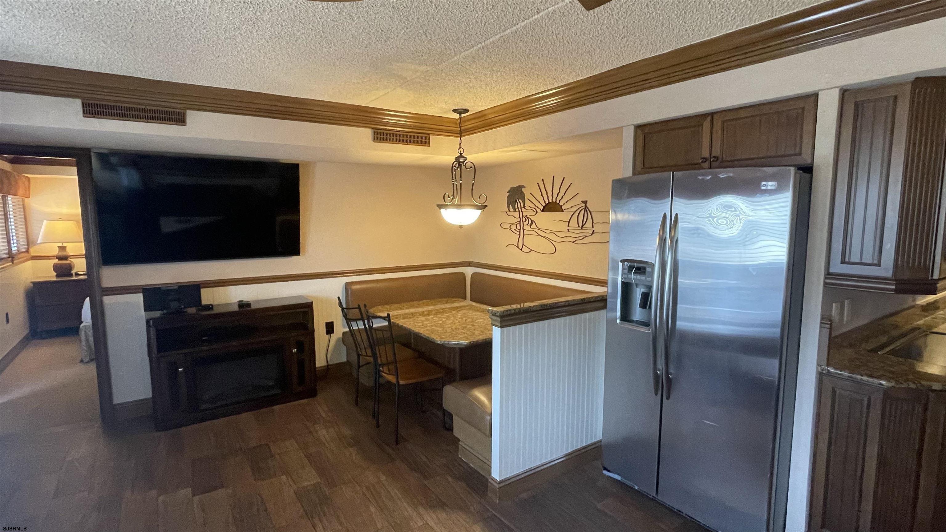 820 Ocean Avenue, Unit 115 Ocean City, NJ 08226 - Photo 34 of 58 a view of a livingroom with furniture and a flat screen tv