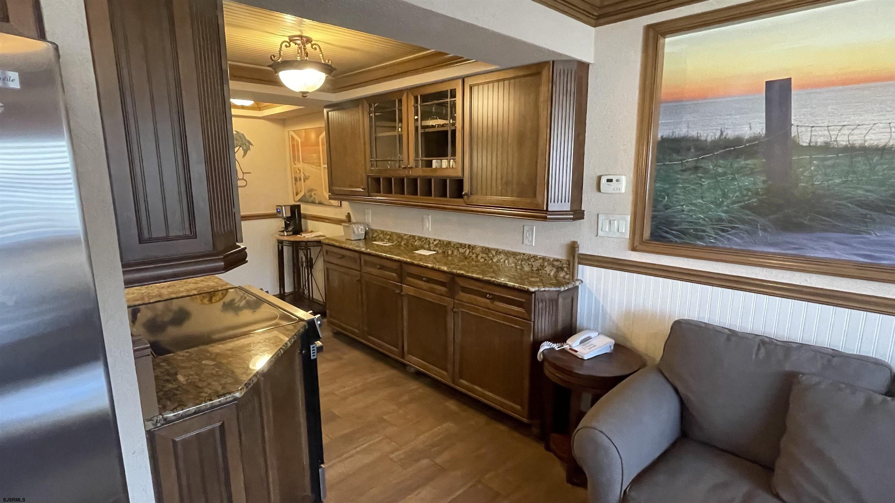 820 Ocean Avenue, Unit 115 Ocean City, NJ 08226 - Photo 37 of 58 a kitchen with stainless steel appliances granite countertop a refrigerator and a sink