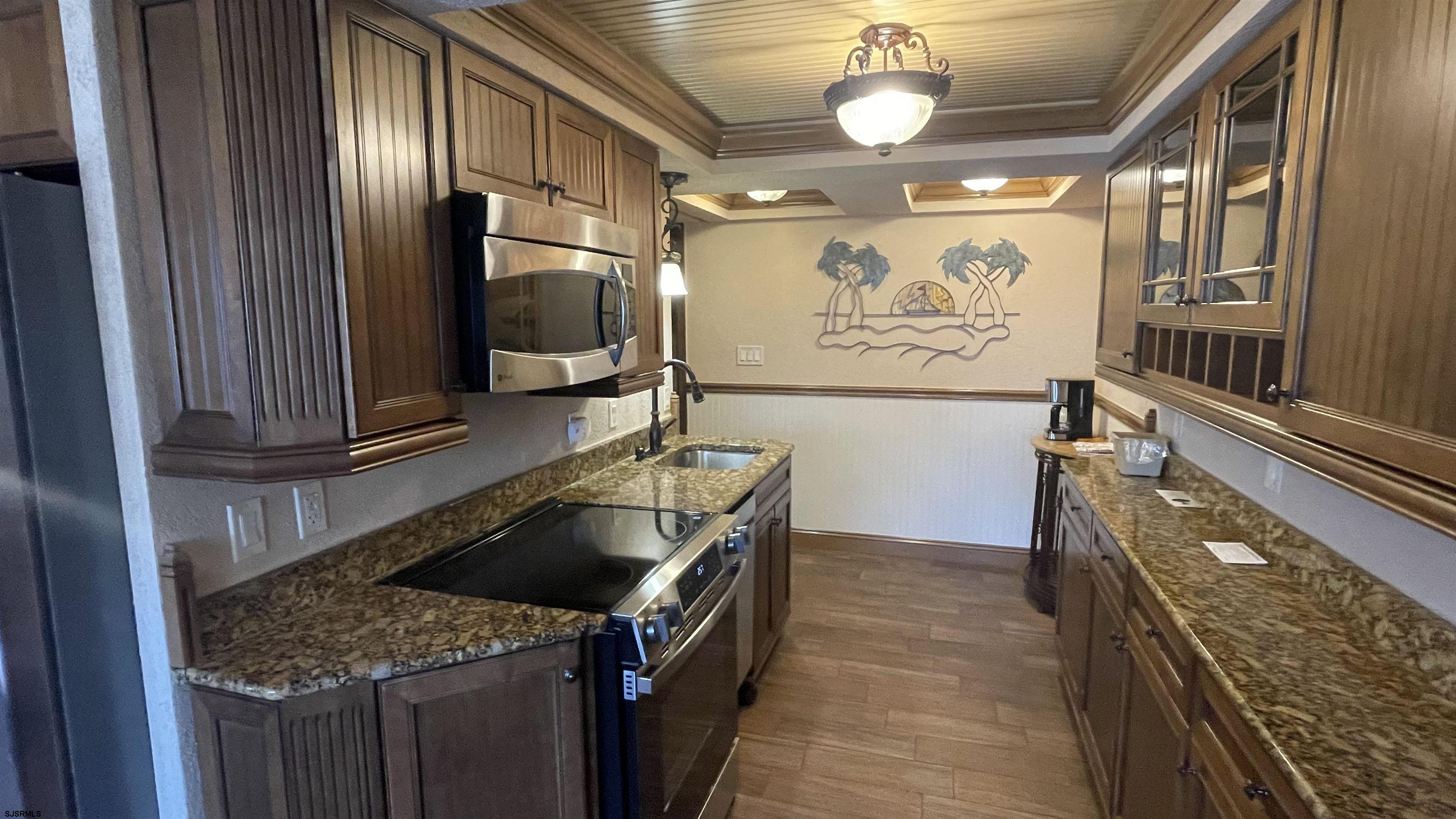 820 Ocean Avenue, Unit 115 Ocean City, NJ 08226 - Photo 39 of 58 a kitchen with a stove and a refrigerator