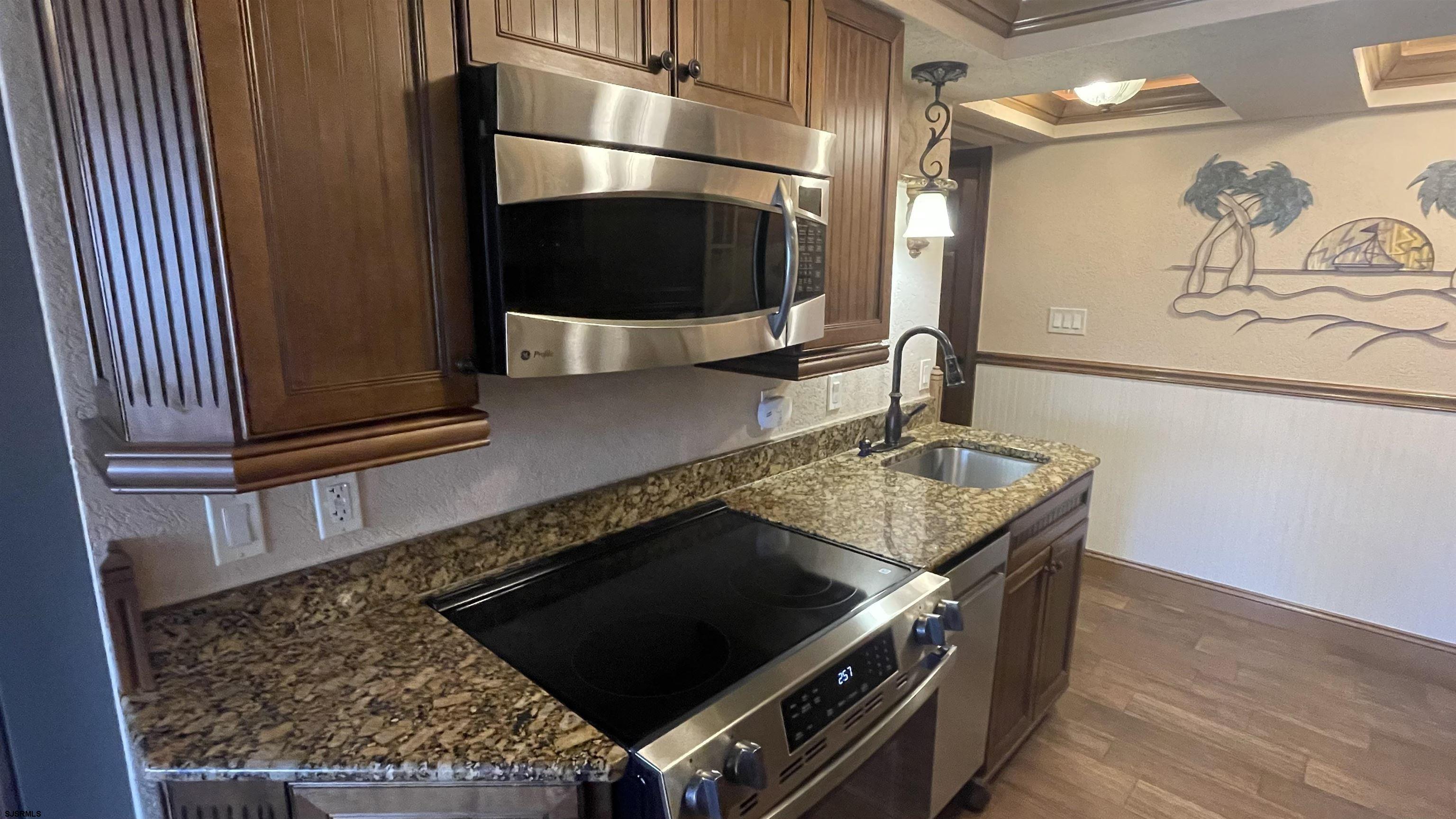 820 Ocean Avenue, Unit 115 Ocean City, NJ 08226 - Photo 41 of 58 a kitchen with a stove and a microwave