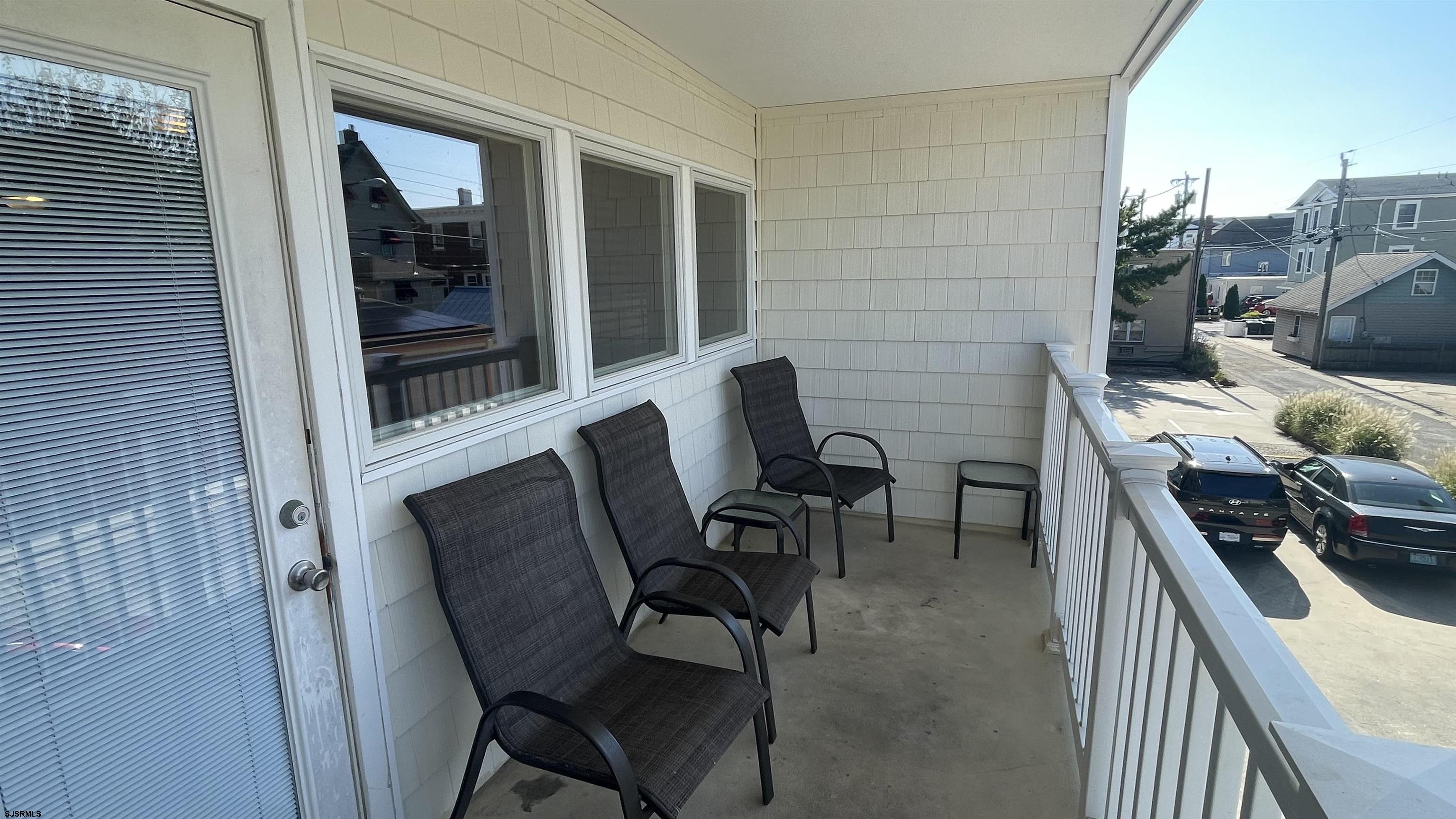 820 Ocean Avenue, Unit 115 Ocean City, NJ 08226 - Photo 52 of 58 a balcony with table and chairs