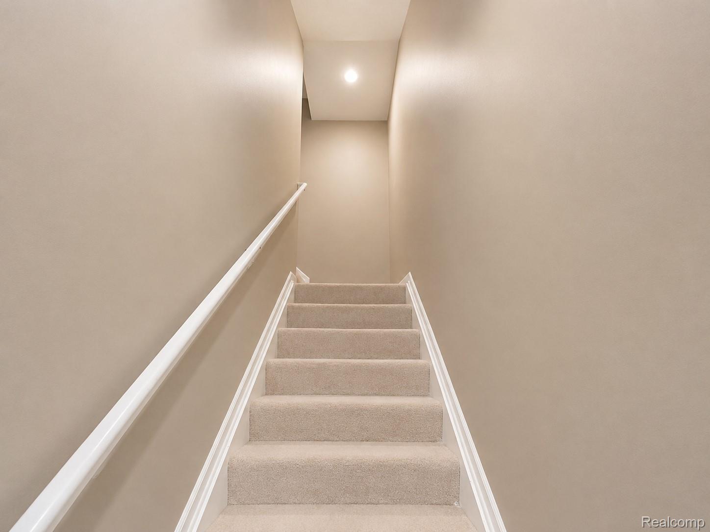 915 Barclay Circle Rochester, MI 48307 - Photo 7 of 14 Carpeted staircase featuring a white handrail and recessed ceiling lighting