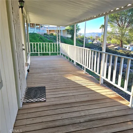 a view of a balcony with wooden floor