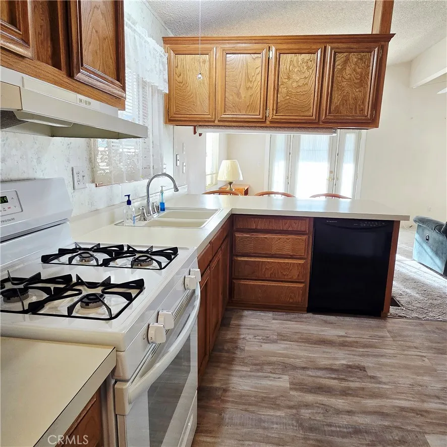 1536 South State Street, Unit 219 Hemet, CA 92543 - Photo 13 of 23 a kitchen with a sink and a stove next to a window
