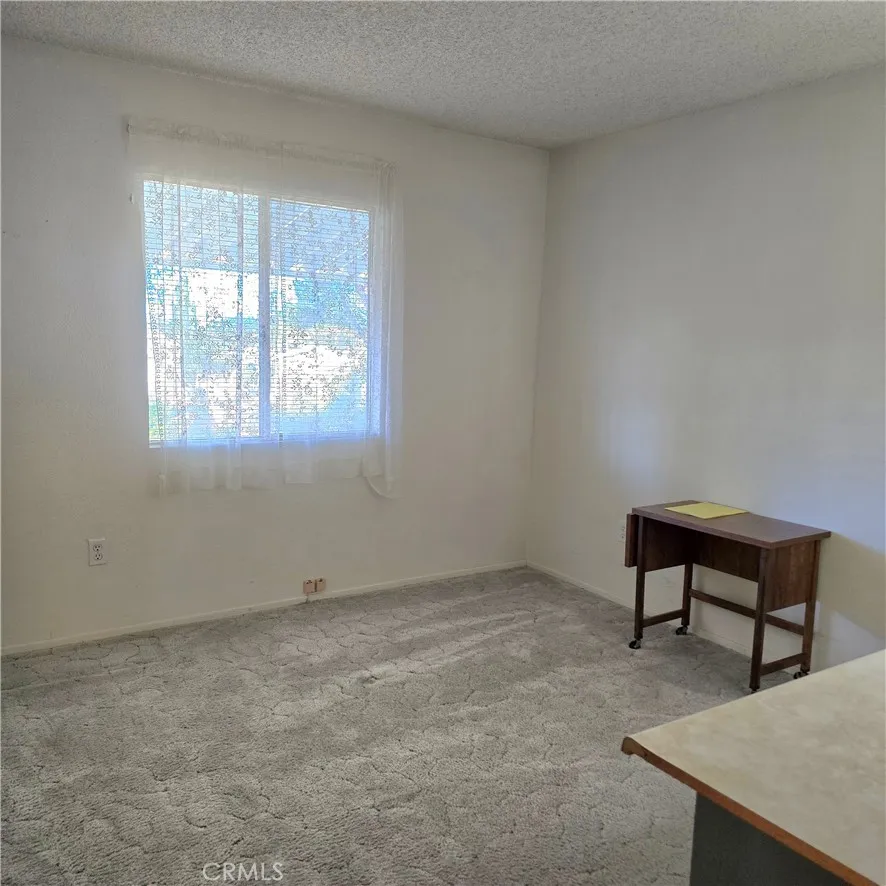 1536 South State Street, Unit 219 Hemet, CA 92543 - Photo 16 of 23 a room with windows and a table