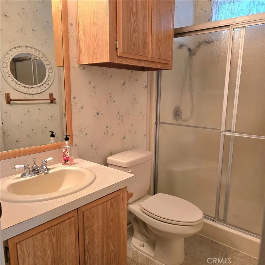 1536 South State Street, Unit 219 Hemet, CA 92543 - Photo 18 of 23 a bathroom with a sink a toilet and a mirror