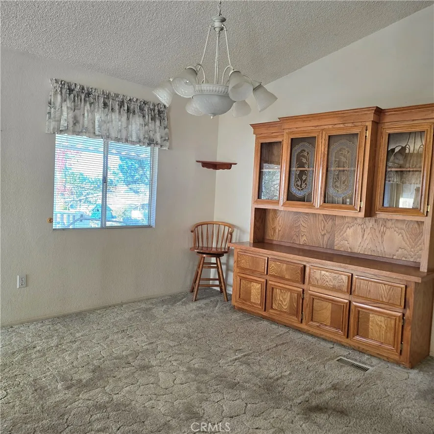 1536 South State Street, Unit 219 Hemet, CA 92543 - Photo 10 of 23 a room with chandelier fan and windows