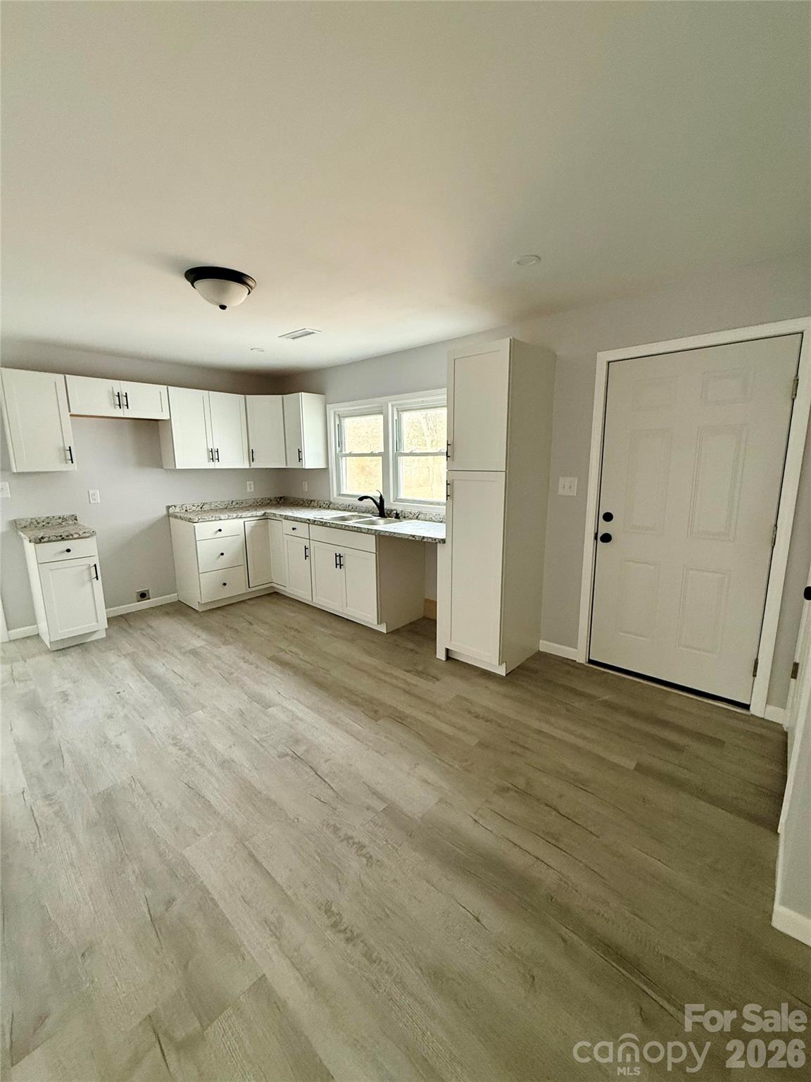 6457 Hudlow Road Union Mills, NC 28167 - Photo 4 of 14 a large white kitchen with a stove a sink and dishwasher