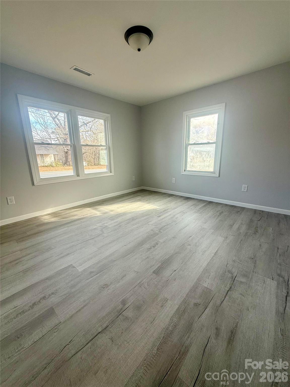 6457 Hudlow Road Union Mills, NC 28167 - Photo 8 of 14 an empty room with wooden floor and windows