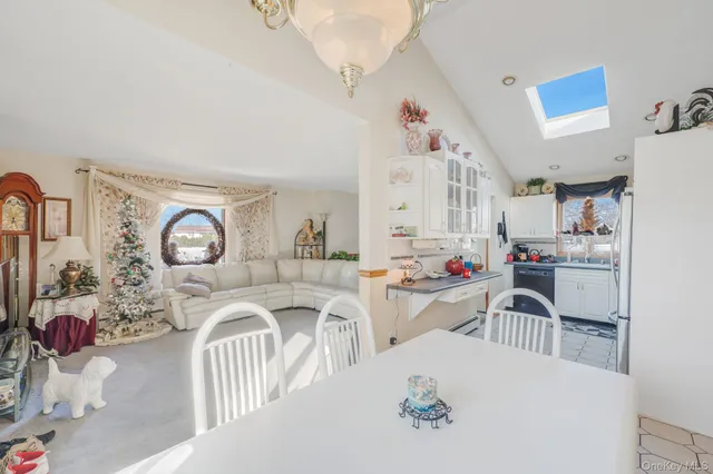 a view of a dining room with furniture and a chandelier