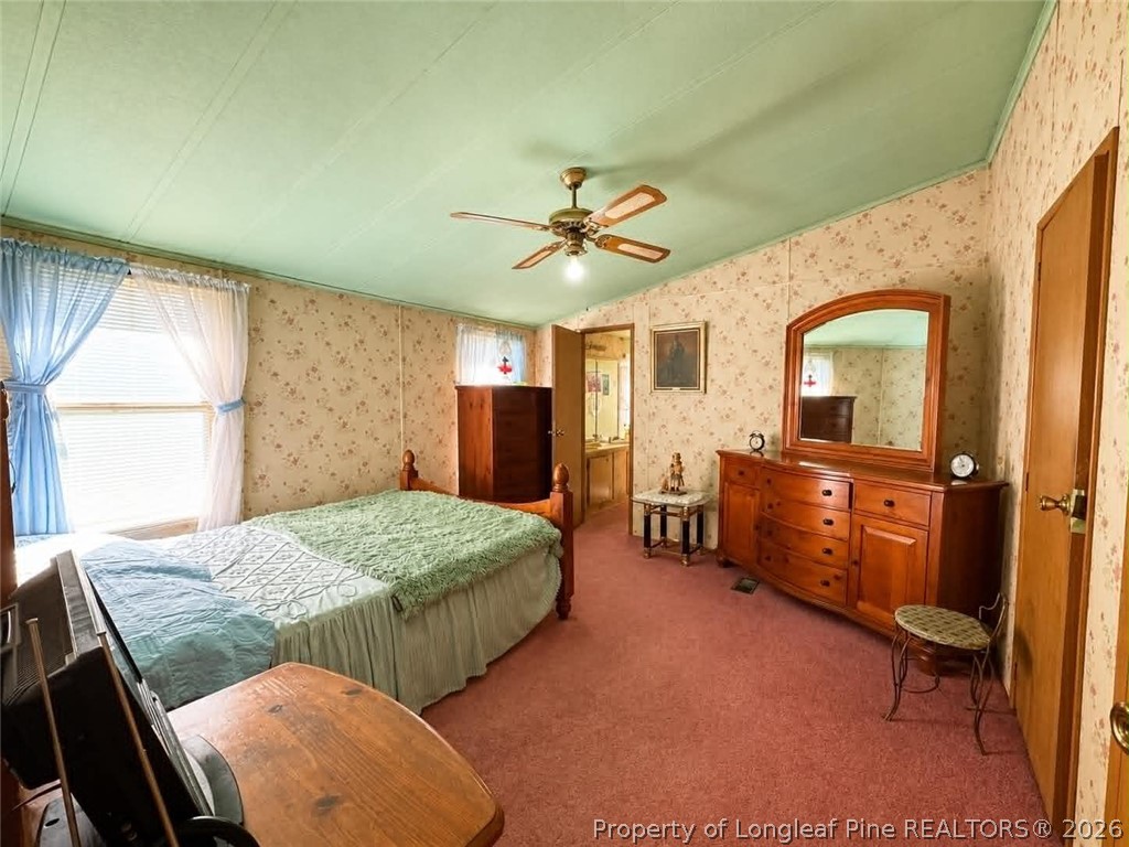 4435 Tartt's Mill Road Wilson, NC 27893 - Photo 10 of 23 a bedroom with a bed and a table chair