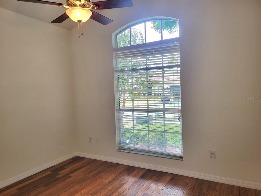 2011 Cattleman Drive Brandon, FL 33511 - Photo 12 of 40 a view of an empty room with wooden floor and a window