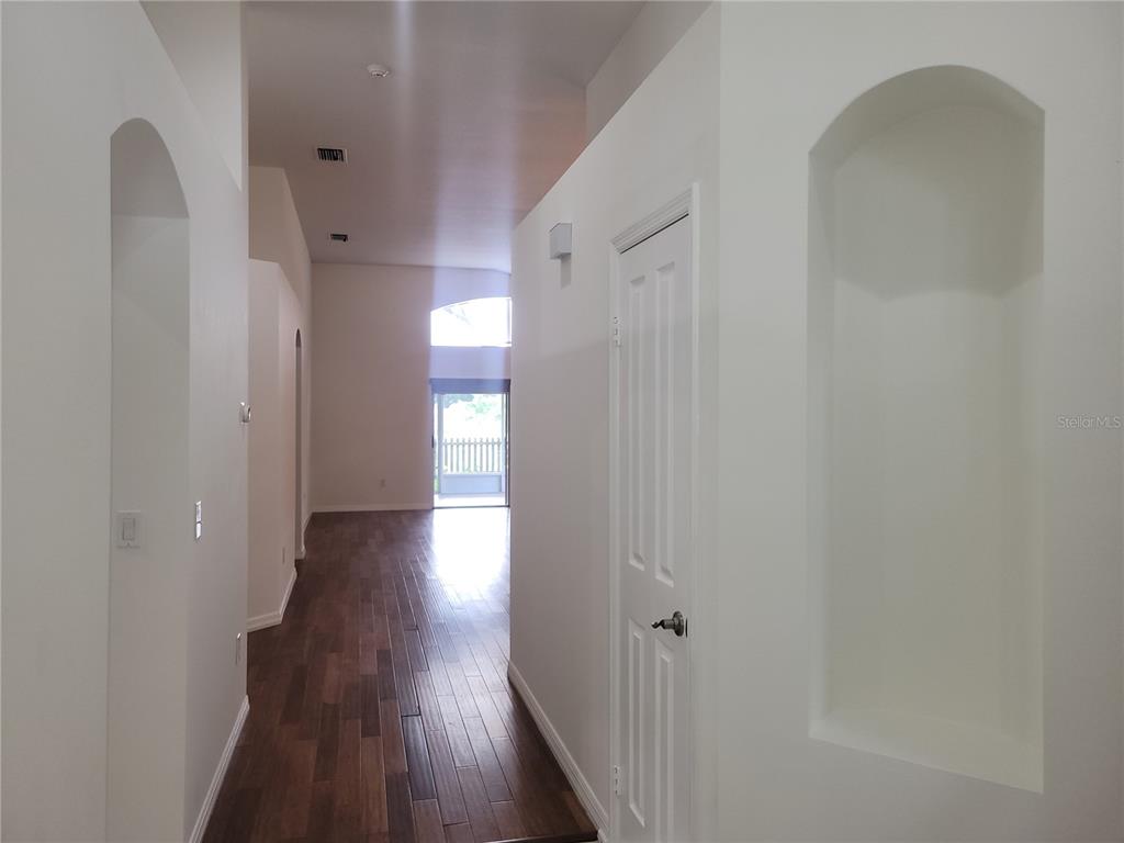 2011 Cattleman Drive Brandon, FL 33511 - Photo 14 of 40 a view of a hallway with wooden floor and staircase