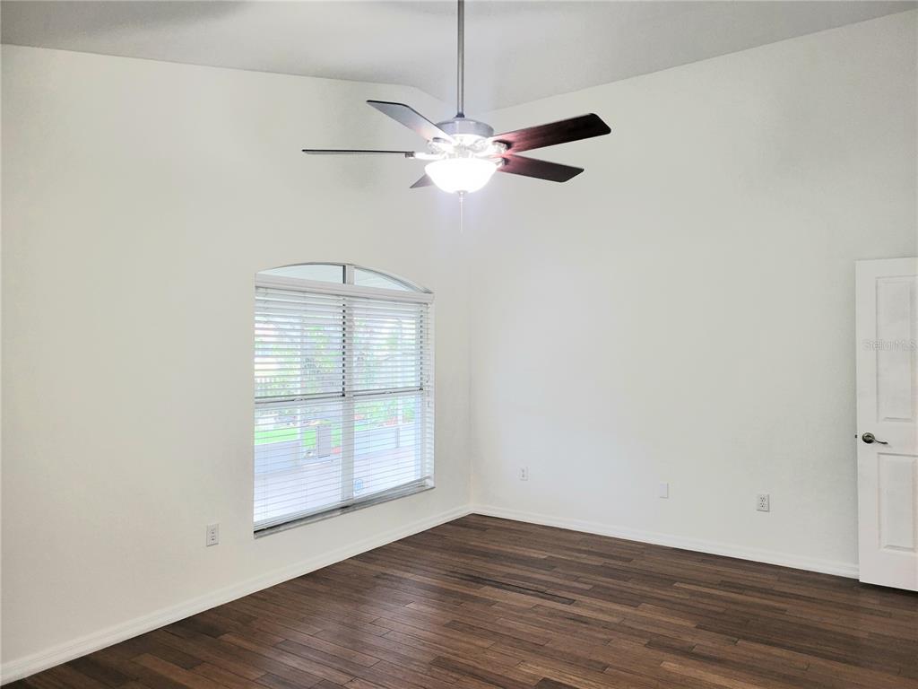 2011 Cattleman Drive Brandon, FL 33511 - Photo 17 of 40 an empty room with wooden floor fan and windows
