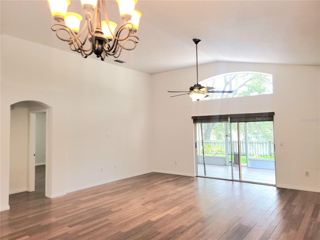 2011 Cattleman Drive Brandon, FL 33511 - Photo 22 of 40 a view of a room with wooden floor and chandelier