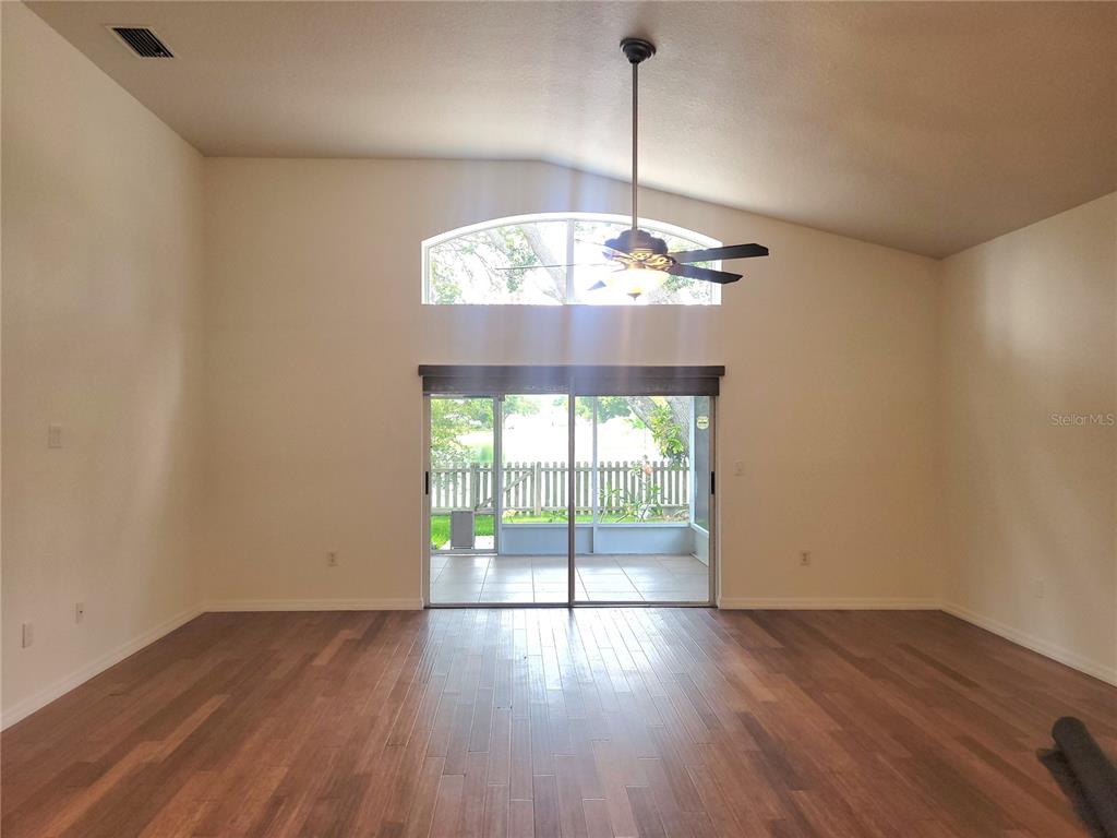 2011 Cattleman Drive Brandon, FL 33511 - Photo 9 of 40 a view of an empty room with wooden floor and a chandelier