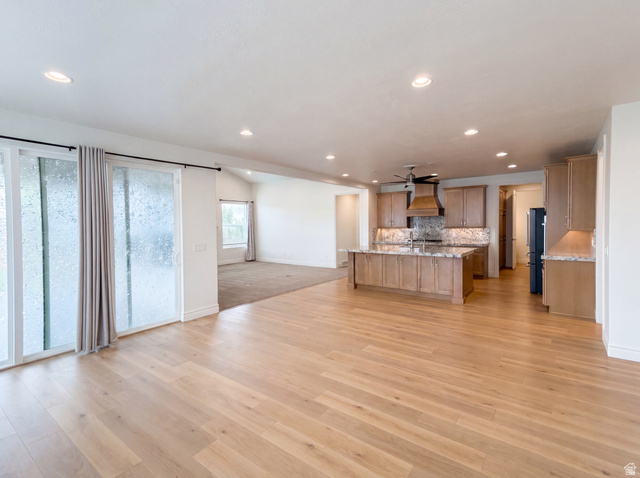 1251 North 2525 West Clinton, UT 84015 - Photo 10 of 30 Expansive open-concept living space featuring light wood-finish flooring, recessed lighting, and a modern kitchen