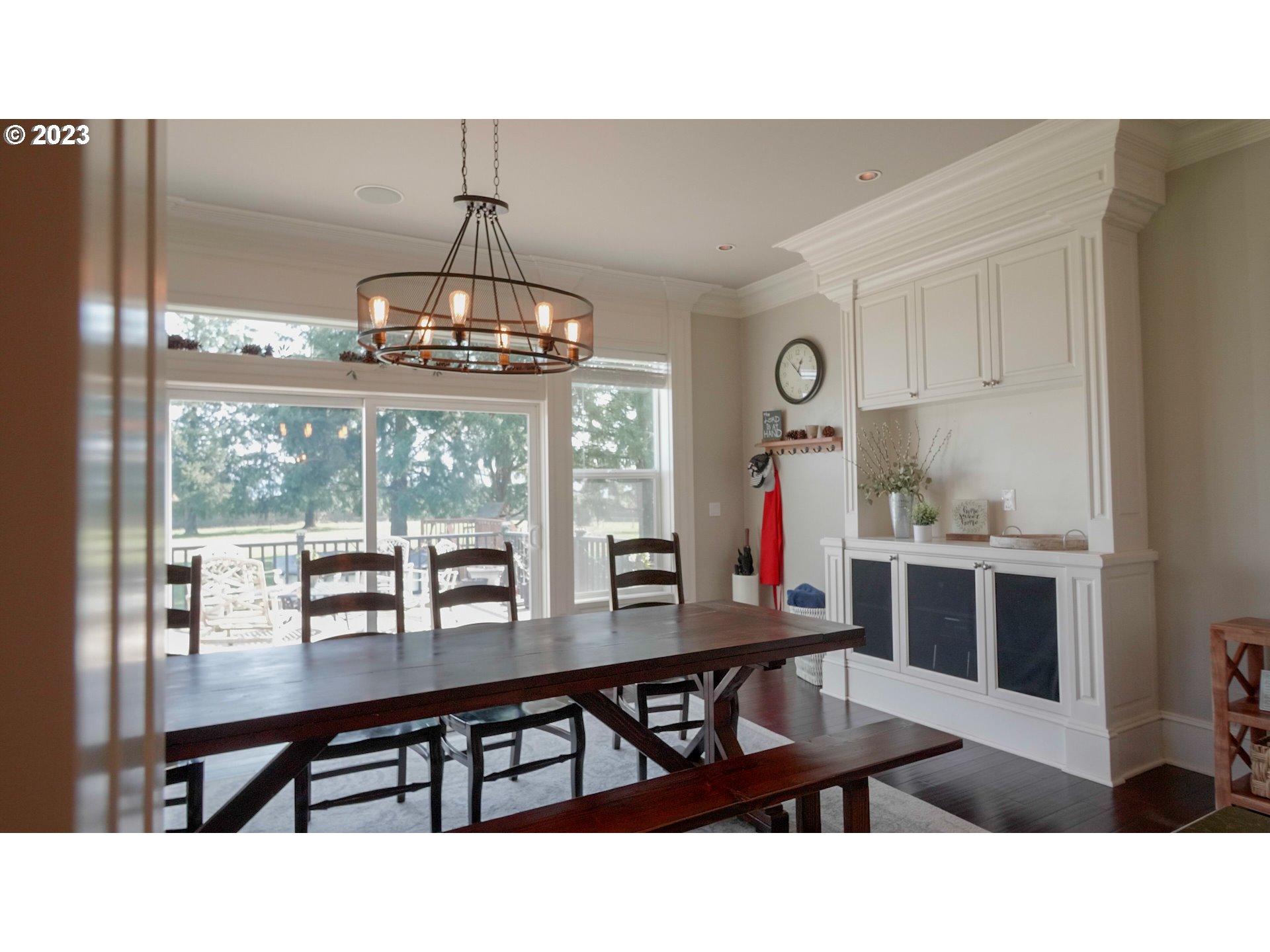 14976 South Hoffman Road Oregon City, OR 97045 - Photo 8 of 26 a dining room with wooden floor a chandelier a wooden table and chairs