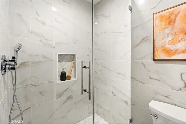 a bathroom with a shower and toilet