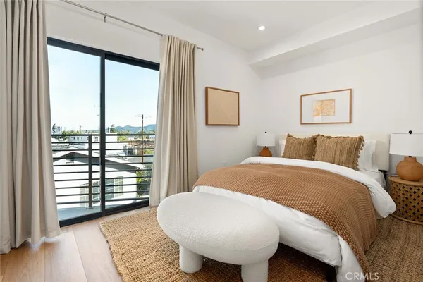 a spacious bedroom with a bed and a large window