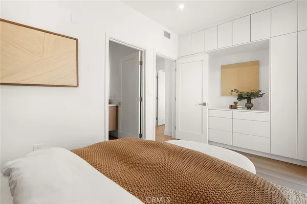 a bedroom with a bed and a cabinets