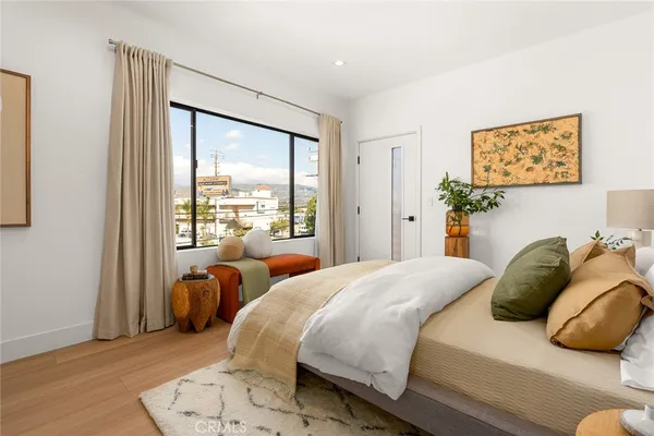 a bedroom with a bed and glass window