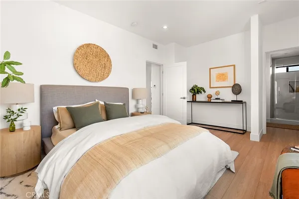 a bedroom with a bed and a chandelier