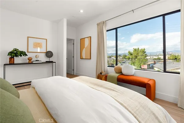 a bedroom with furniture and large windows