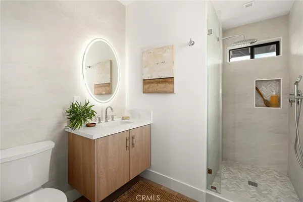 a bathroom with a sink mirror toilet and shower