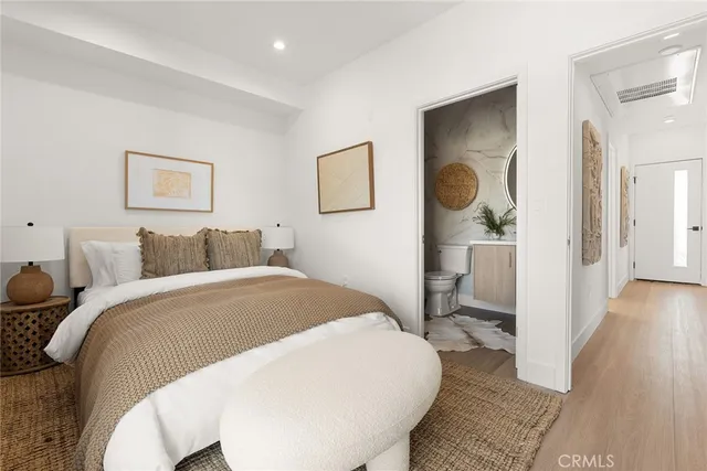 a bedroom with a bed and a painting on the wall