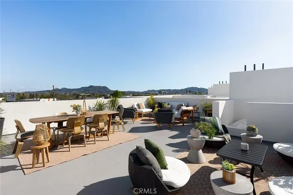 a terrace with outdoor seating and city view