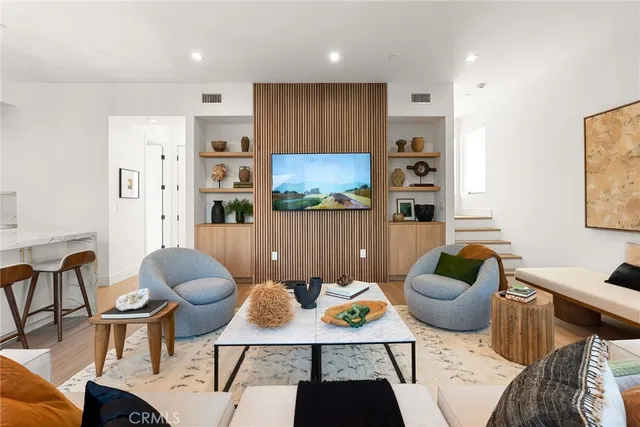 a living room with furniture and a painting on the wall