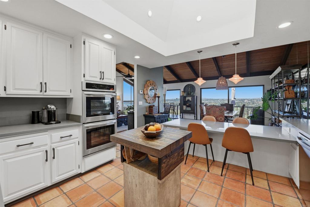 2414 Sacada Circle Carlsbad, CA 92009 - Photo 14 of 56 a kitchen with stainless steel appliances granite countertop a stove and cabinets
