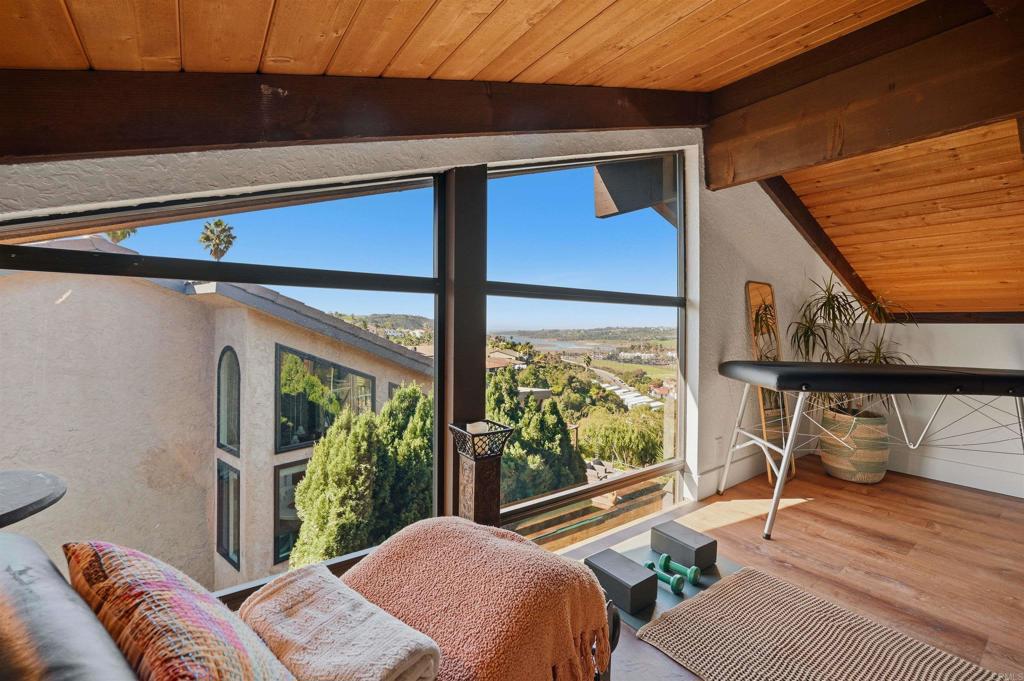 2414 Sacada Circle Carlsbad, CA 92009 - Photo 22 of 56 a bedroom with a bed and wooden floor