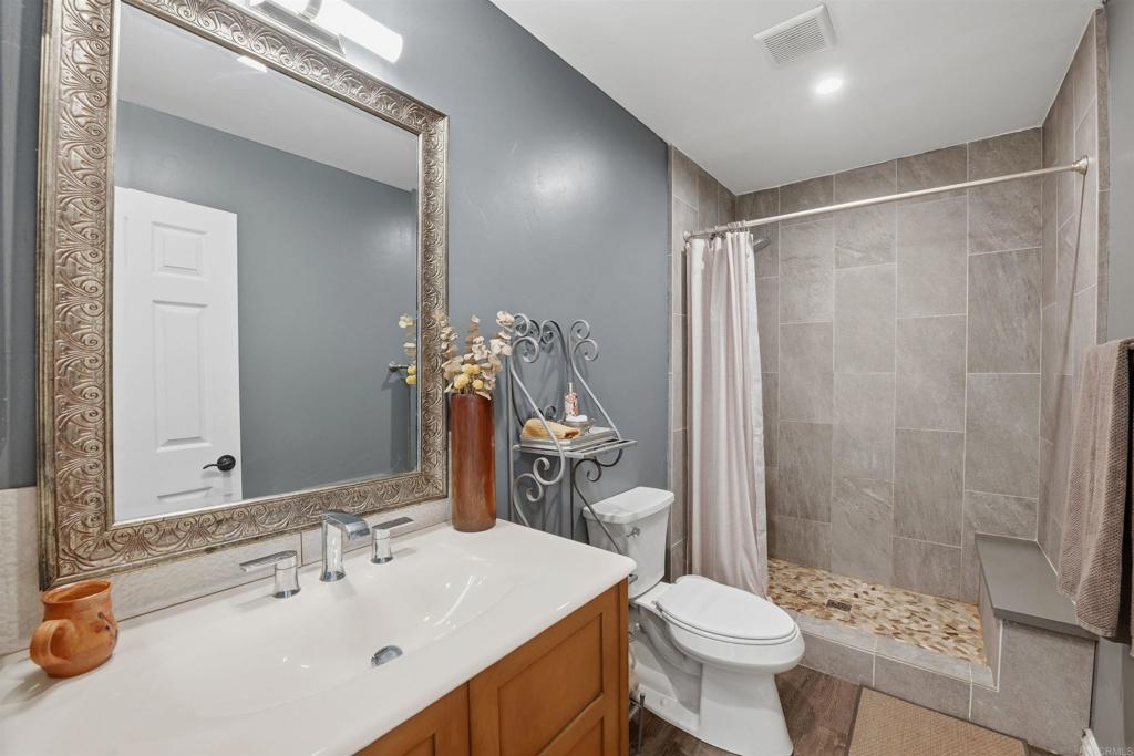 2414 Sacada Circle Carlsbad, CA 92009 - Photo 25 of 56 a bathroom with a sink toilet and shower