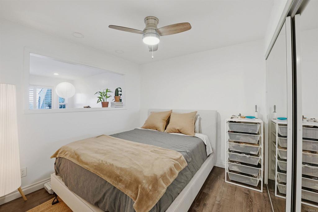 2414 Sacada Circle Carlsbad, CA 92009 - Photo 29 of 56 a bedroom with a bed and a chandelier