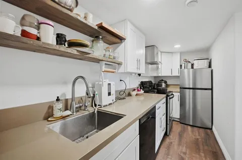 a view of a patio with couches table and chairs and potted plants