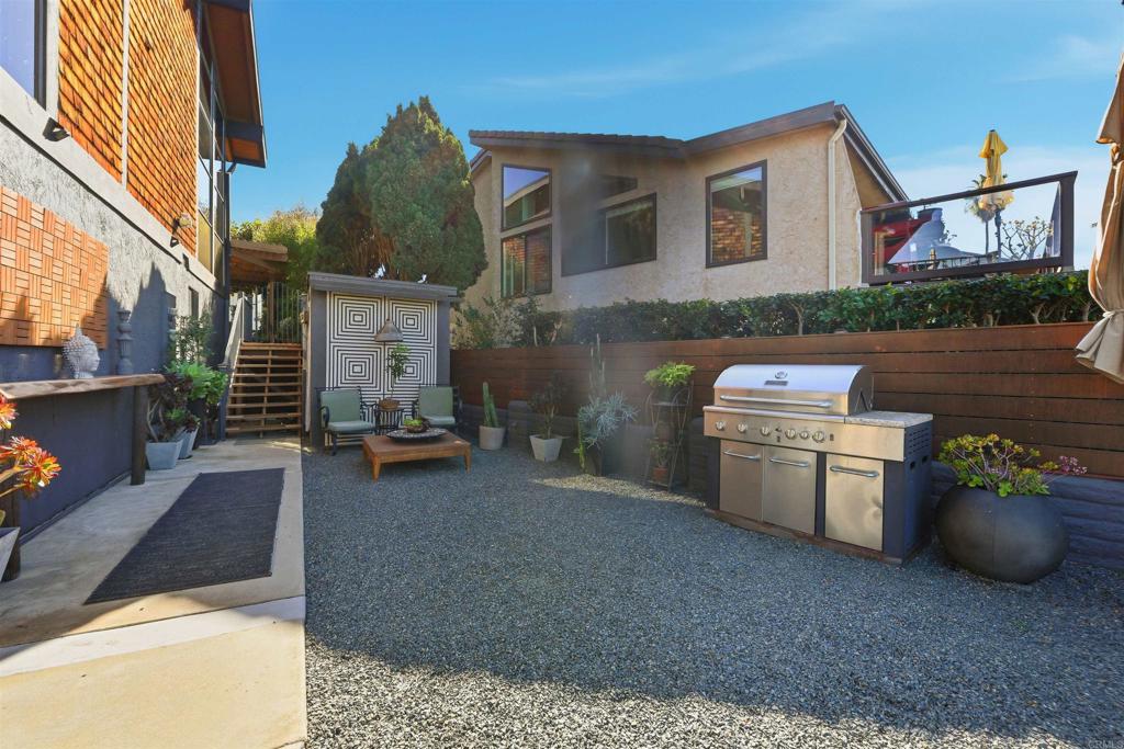 2414 Sacada Circle Carlsbad, CA 92009 - Photo 36 of 56 a backyard of a house with barbeque oven fire pit and outdoor seating