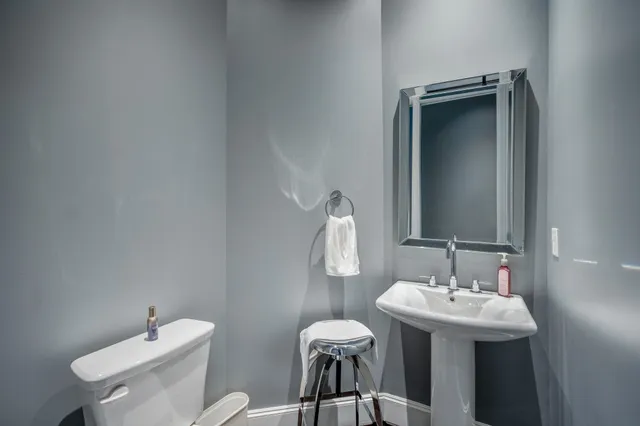 a bathroom with a sink toilet and mirror