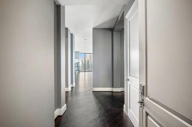 a view of a hallway with wooden floor