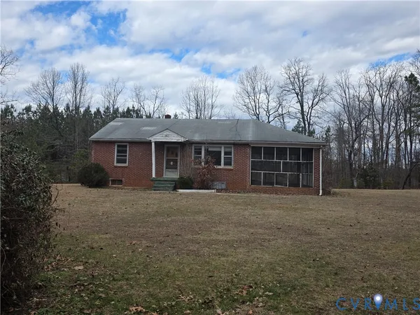 a front view of a house with yard and trees