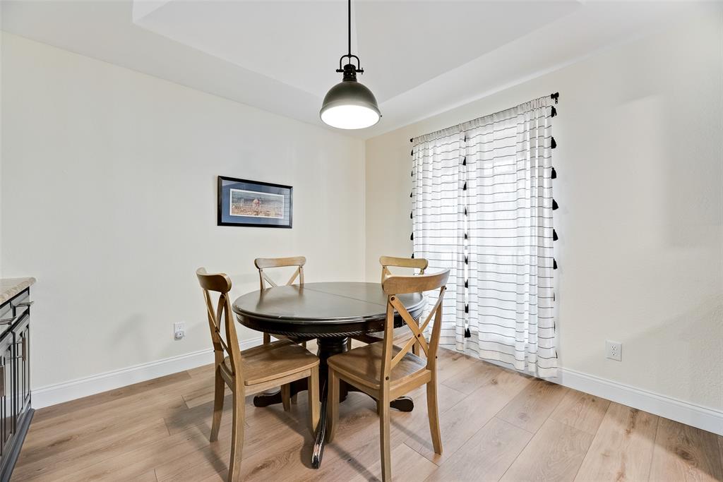 740 Newport Road Fort Worth, TX 76120 - Photo 13 of 38 a view of a dining room with furniture and wooden floor