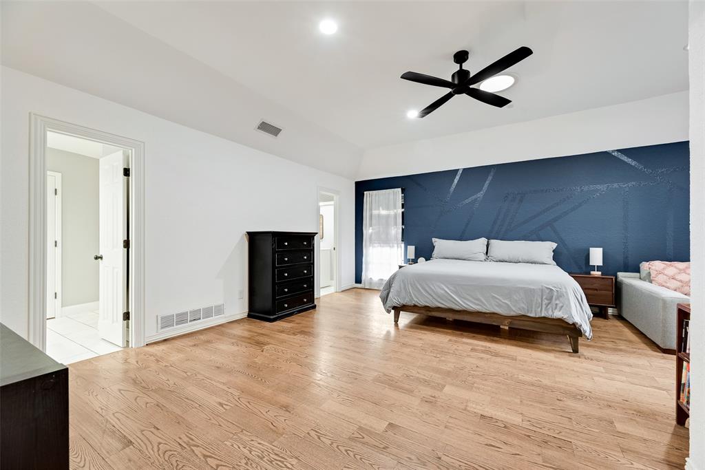 740 Newport Road Fort Worth, TX 76120 - Photo 18 of 38 a bedroom with a bed and a ceiling fan