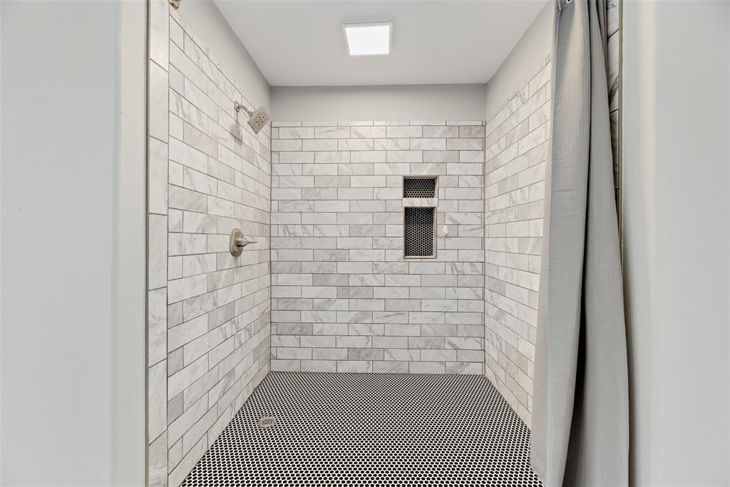 740 Newport Road Fort Worth, TX 76120 - Photo 24 of 38 a bathroom with a shower