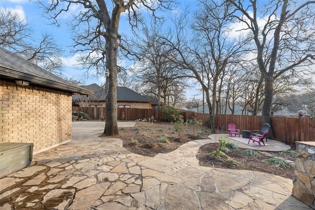 740 Newport Road Fort Worth, TX 76120 - Photo 34 of 38 a backyard of a house with fire pit and outdoor seating