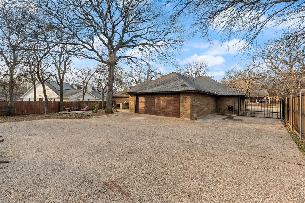 740 Newport Road Fort Worth, TX 76120 - Photo 36 of 38 a front view of a house with a yard and garage