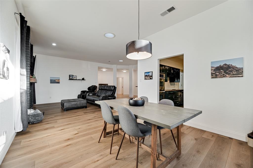 740 Newport Road Fort Worth, TX 76120 - Photo 6 of 38 a view of a dining room with furniture and wooden floor